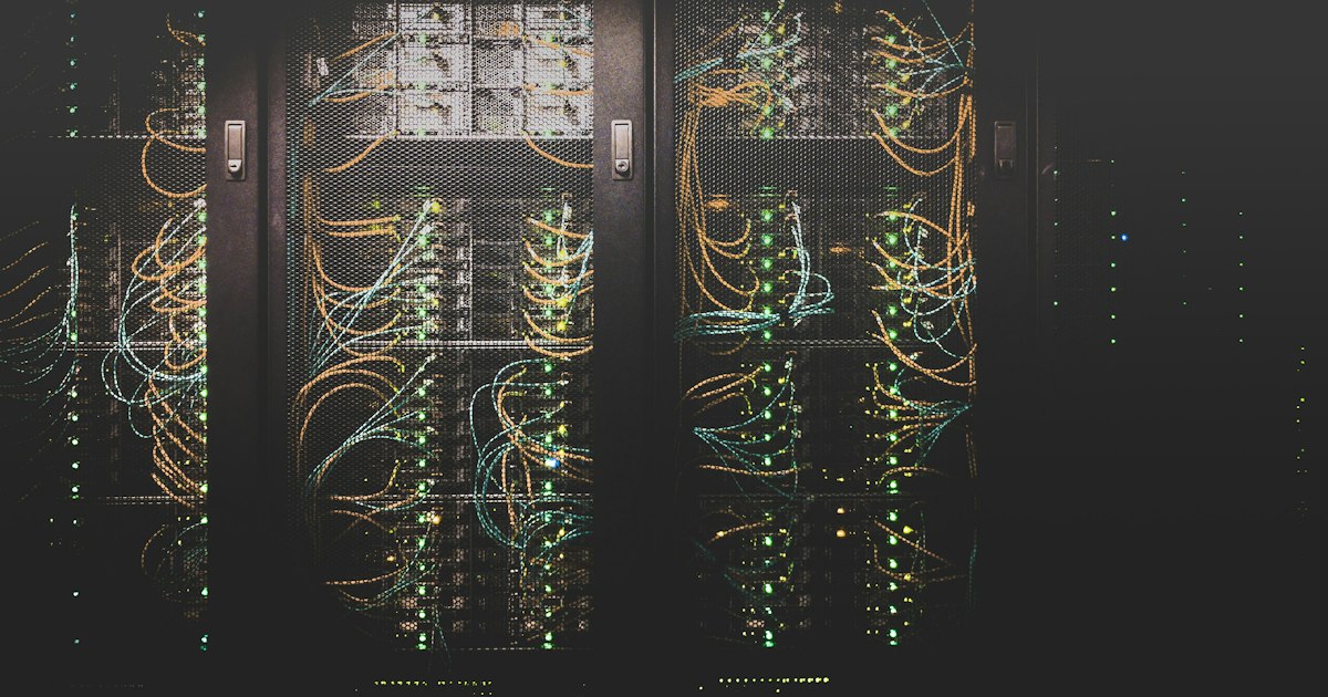 Server room with rows of data center racks and blue LED lighting
