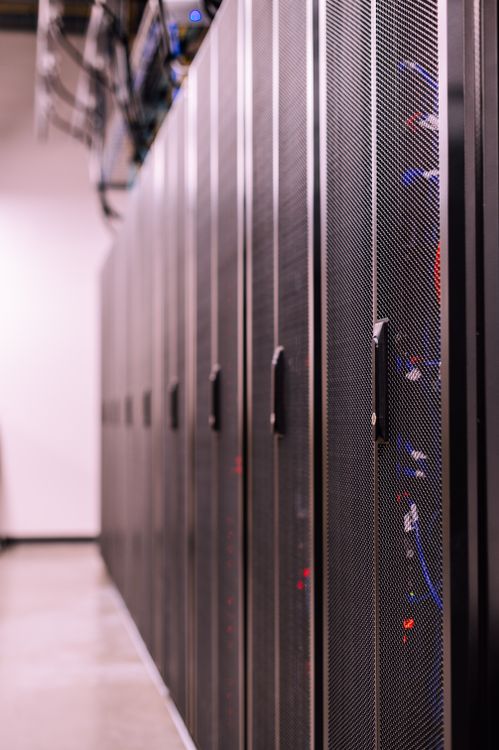 Black server racks in a modern data center showing network infrastructure