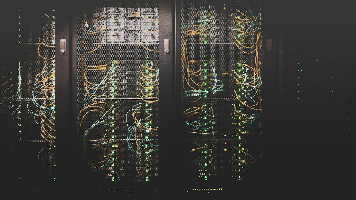 Rows of server racks in a datacenter with blue indicator lighting