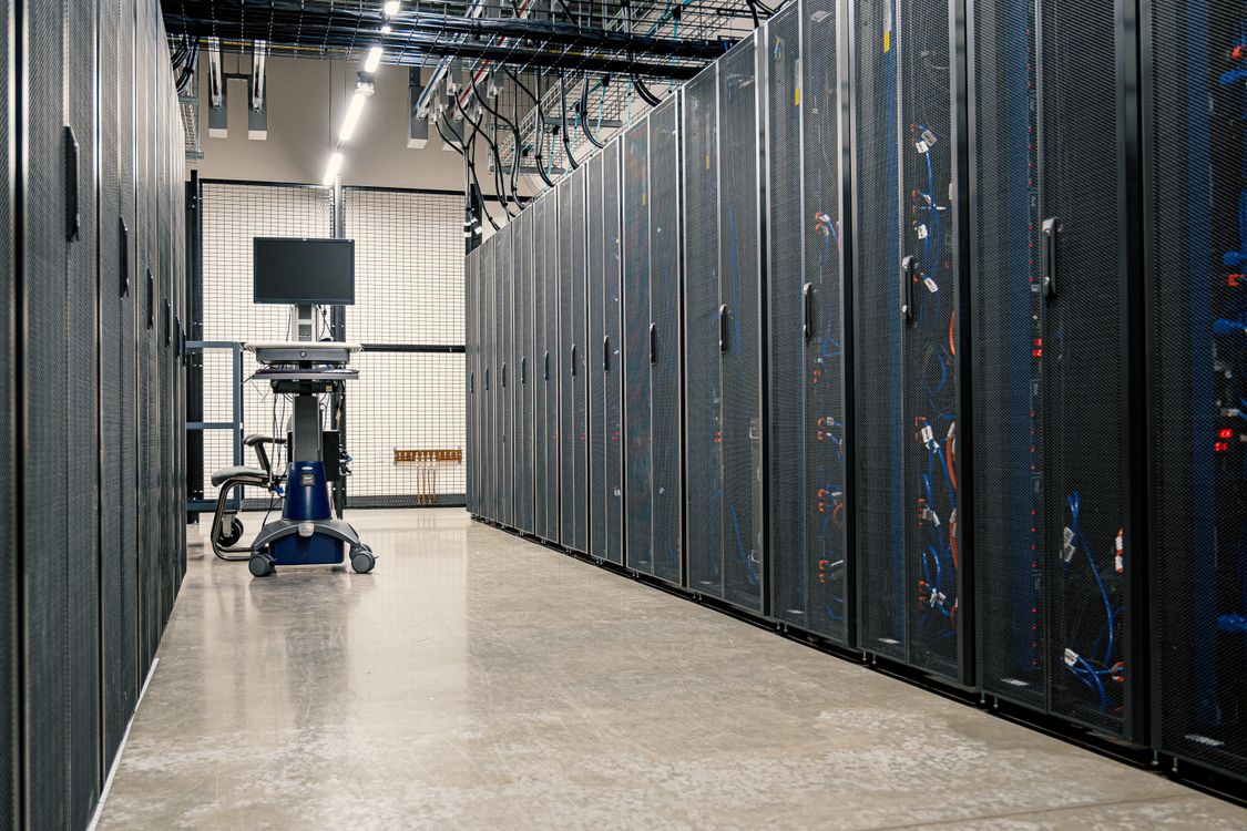 Server racks with blue indicator lights in a data center corridor