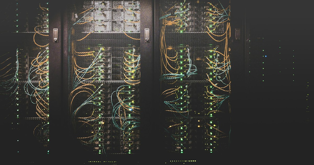 Rows of illuminated rack-mounted servers in a modern data center