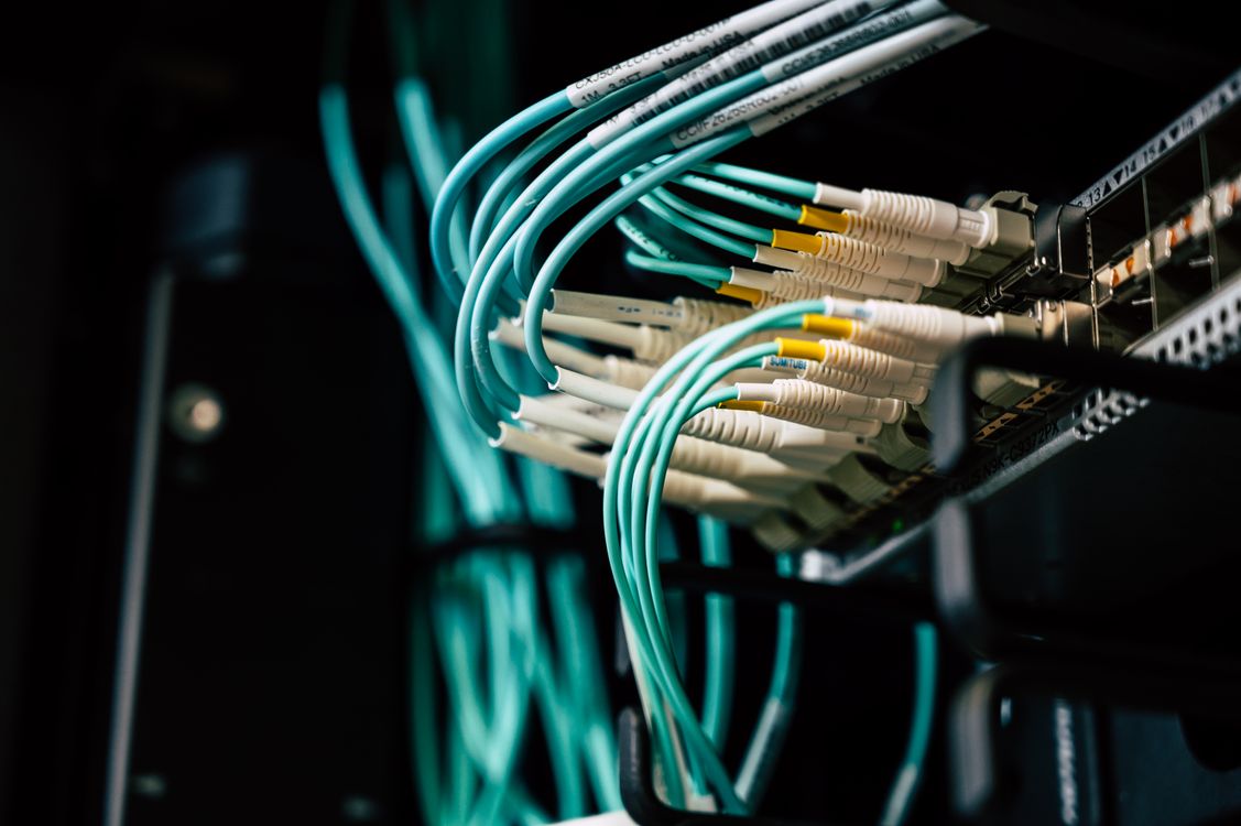 Network cables connected to server ports in a data center rack