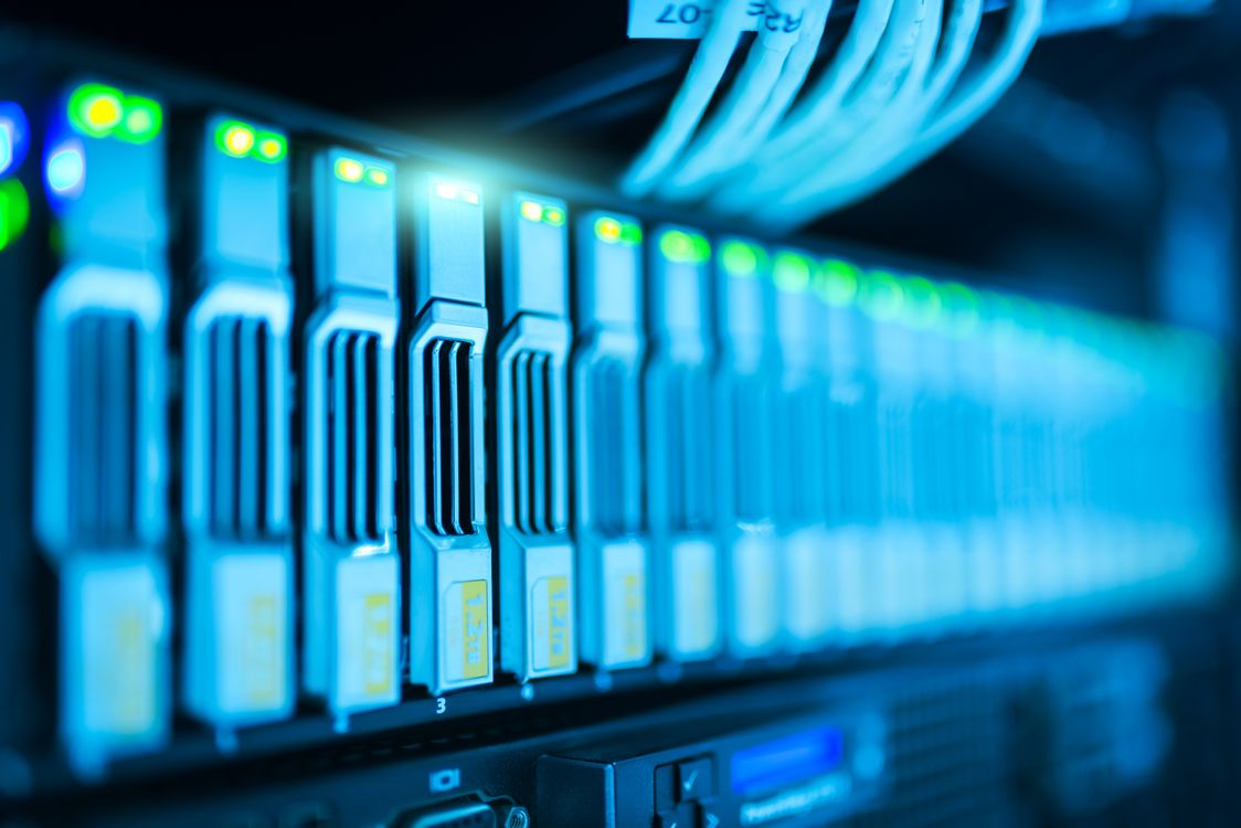 Close-up of server hardware with glowing LED status lights in a data center