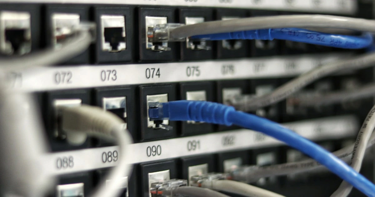 Network cables and switches routing traffic inside a server rack