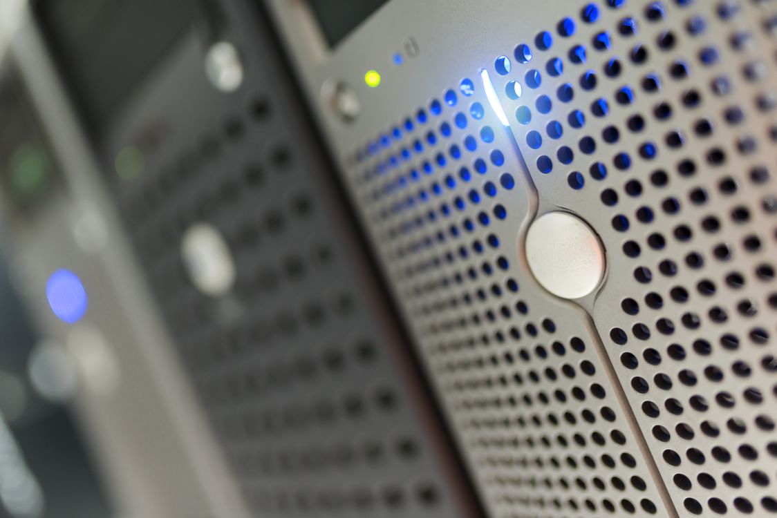 Close-up of server hardware with blue LED status indicators in a data center